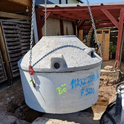 Hier wird eine Betonzisterne 5000 Liter gerade mit dem Kran versetzt